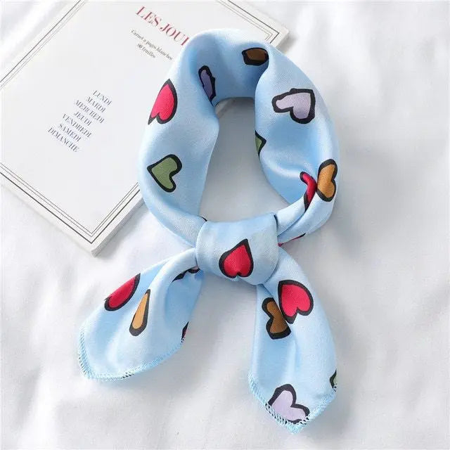Elegant silk scarf featuring a charming heart print, perfect fashion accessory for women seeking stylish looks.