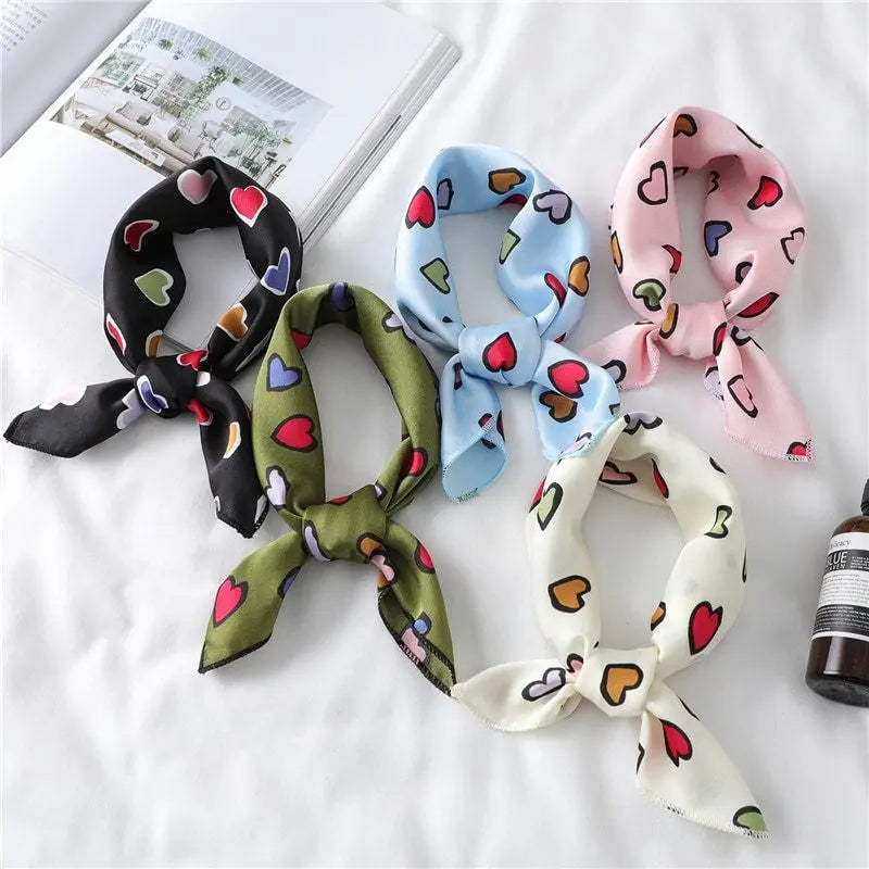 Elegant silk scarf featuring a charming heart print, perfect fashion accessory for women seeking stylish looks.