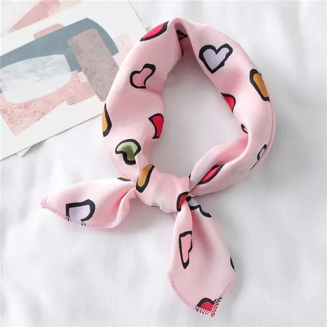 Elegant silk scarf featuring a charming heart print, perfect fashion accessory for women seeking stylish looks.