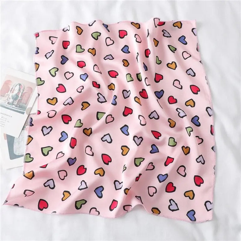 Elegant silk scarf featuring a charming heart print, perfect fashion accessory for women seeking stylish looks.